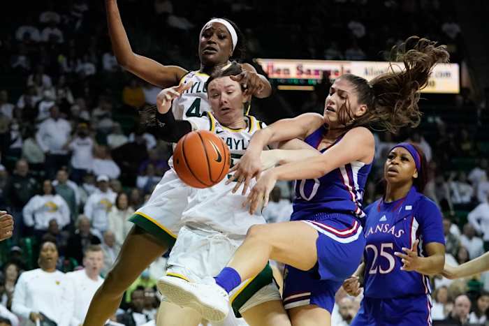 Feb 26, 2022; Waco, Texas, USA; Baylor Lady Bears forward Caitlin Bickle (51) and Kansas Jayhawks forward Ioanna Chatzileonti (10) fight for a loose ball during the second half at Ferrell Center. Mandatory Credit: Chris Jones-USA TODAY Sports